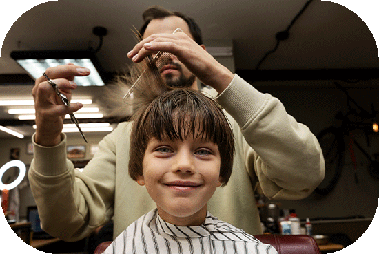 smiling kid getting hair cut